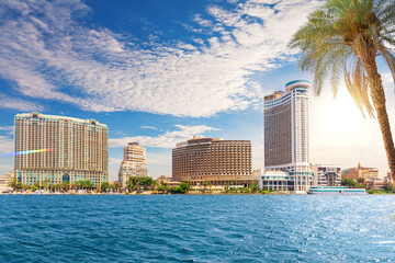Colorful view of luxury center of Cairo with Skyscrapers and palms on the Nile, Egypt © AlexAnton