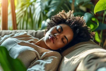 Foto op Aluminium Relaxed tired young african american woman napping on comfortable sofa with eyes shut closed. Calm lazy black girl leaning on couch in living room enjoying chill sleeping resting at home concept © StockWorld