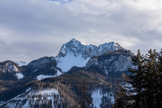 Scenic view of snow capped mountain peak Kosiak in Karawanks, Carinthia, Austria. Winter wonderland in Austrian Alps. Remote alpine landscape in Baerental. Tranquil and serene atmosphere in nature