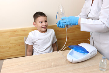 The boy is preparing for the nebulizer inhalation procedure.