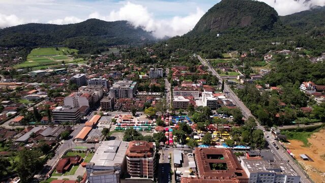 Aerial drone reveal of stands in the Feira do Alto in Teresopolis, Rio de Janeiro, Brazil with a reveal of the surrounding landscape