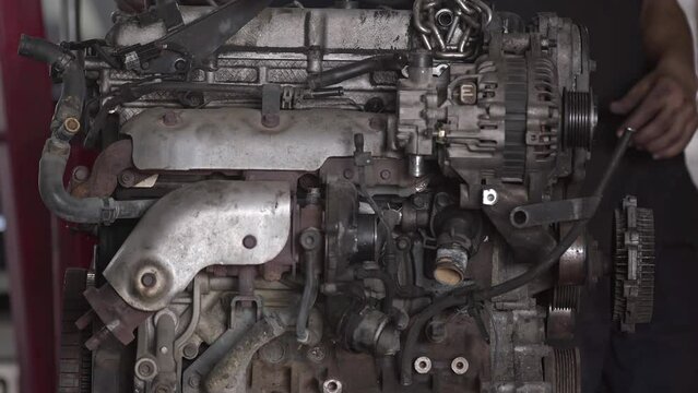 Car Mechanic Repairs Car Engine in Workshop with Pliers Footage.