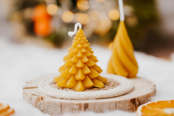 Beeswax spruce shaped candles on light background