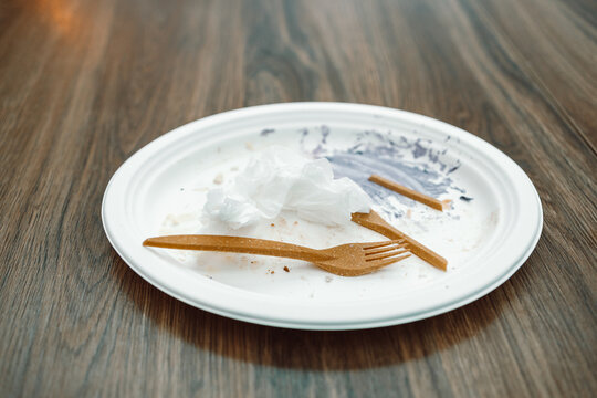 Empty dirty plastic plate and plastic fork in cafe. High quality photo