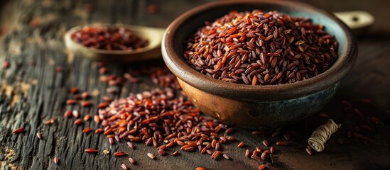 Red yeast rice, dried, in bowl and on spoon. - obrazy, fototapety, plakaty