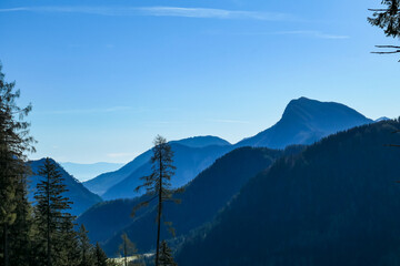 Panoramic view of misty Karawanks mountain range on sunny day in Carinthia, Austria. Remote high...