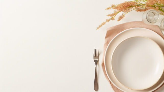 Clean empty beige plate with knife and fork