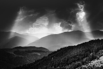 Amazing landscape of mountains hills in sunbeam and cloudy sky in black and white shadow light. Monochrome style. - 698743668