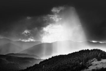 Amazing landscape of mountains hills in sunbeam and cloudy sky in black and white shadow light. Monochrome style. - 698743689