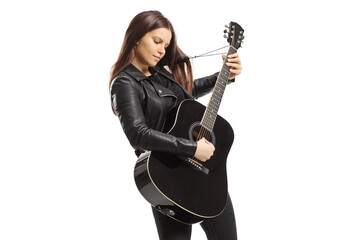 Young female playing an acoustic guitar