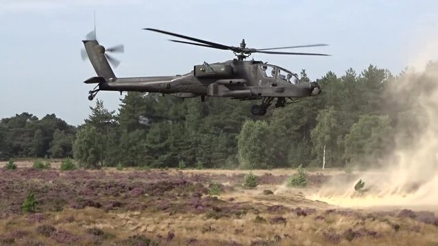Military Helicopter Flying Low through sand