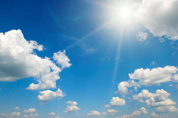 Bright sun on beautiful blue sky with white clouds. - 698755094