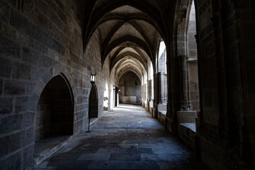 Fototapeta na wymiar Interior corridor in ancient landmark building with gothic arch in a medieval architecture in Narbonne, France