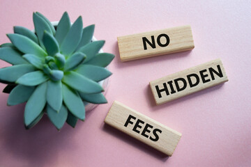 No Hidden Fees symbol. Concept words No Hidden Fees on wooden blocks. Beautiful pink background...