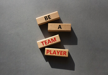 Be a team player symbol. Concept words Be a team player on wooden blocks. Beautiful grey background. Business and Be a team player concept. Copy space