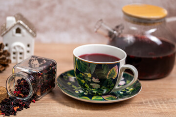 Obraz na płótnie Canvas tea in a cup ,a cup filled with tea next to a jug with tea and dry tea poured from the jar