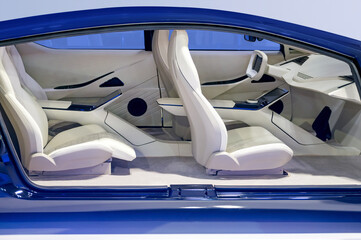 Futuristic blue colored car interior with comfortable seats and dashboard