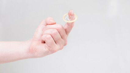 Condom in a man's hand, a means of contraception