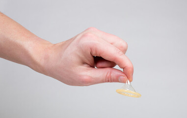 Condom in a man's hand, a means of contraception