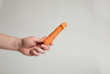 Condom dressed on a carrot, contraception