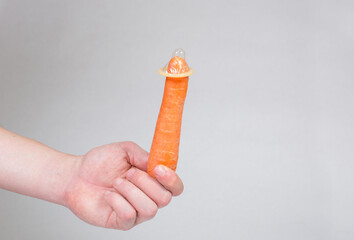 Condom dressed on a carrot, contraception