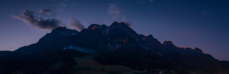 During the Johanni festival, a Christian tradition, people celebrate on the mountain peaks of Wilder Kaiser by enlighting big fires in Austria during July..