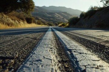 Close-Up View of Road Surface with Distant Mountains