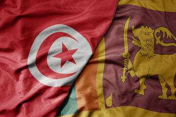 big waving national colorful flag of sri lanka and national flag of tunisia .