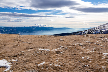 Scenic hiking trail over snow covered alpine meadow between Gertrusk and Ladinger Spitz, Saualpe,...