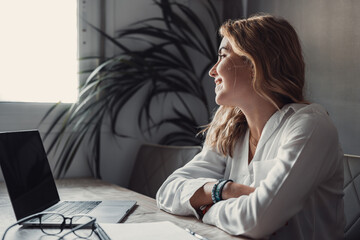 Smiling young caucasian business woman head shot portrait. Thoughtful millennial businesswoman looking away with pensive face, dreaming, thinking over project tasks, future lifestyle.