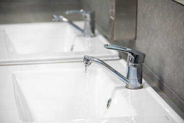 A washbasin with a faucet and a sink for washing hands.