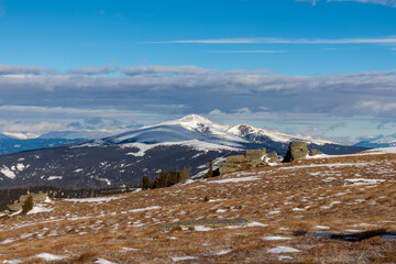 Panoramic view of forest and snow capped mountain peak Zirbitzkogel seen from Forstalpe, Saualpe, Carinthia, Austria, Europe. Alpine hiking trail in Central Alps in winter on sunny day