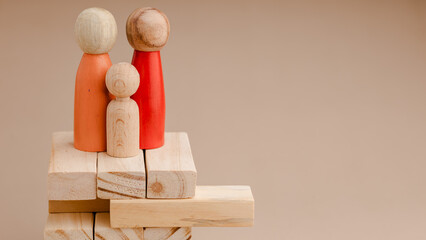 protecting happy wooden doll family or parent father, child and mother. Concept of family care, family protection, life insurance, security, safe, happy, home, house, finance