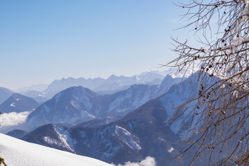 Panoramic aerial view of snow capped mountain ranges of Karawanks, Julian and Kamnik Savinja Alps...
