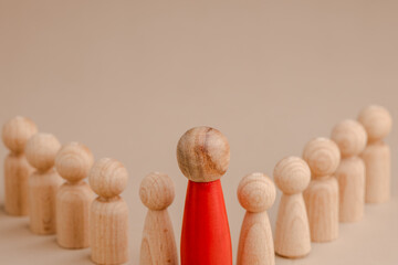 wooden figure representing a leader leading other figures. Leadership concept
 - obrazy, fototapety, plakaty