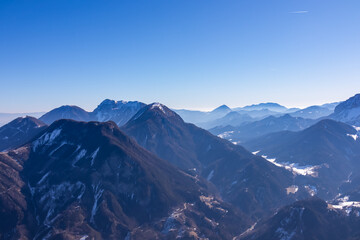 Scenic view on snow capped mountain peaks of Karawanks, Julian and Kamnik Savinja Alps in Carinthia...