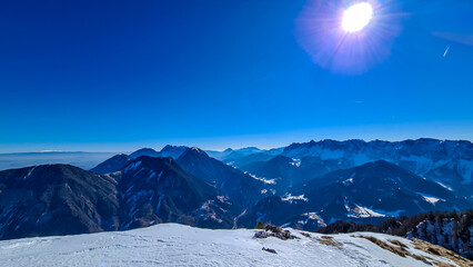 Scenic view on snow capped mountain peaks of Karawanks, Julian and Kamnik Savinja Alps in Carinthia...