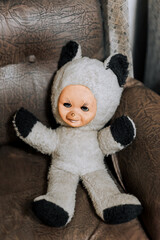 An old retro toy bear from the old times of the USSR lies on a chair. Photography, concept.