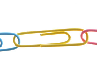 Colorful paperclips connected together, isolated on white. Teamwork concept