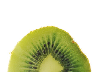 Closeup flatlay view of a kiwi slice isolated on white