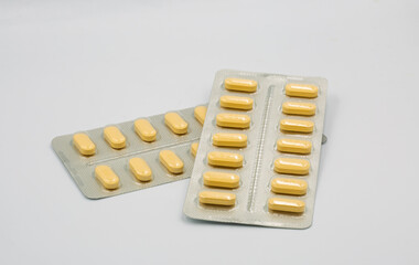 Medical yellow tablets in blisters closeup