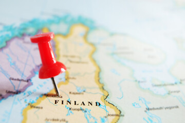 Red locator push pin in a map of Finland