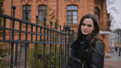 Sensitive portrait of a brunette girl on a cloudy spring day