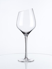 Stylish empty wine glass with beveled edge isolated on white background