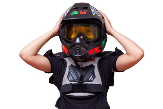 a 10-year-old girl in a motorcycle protection helmet, glasses and a bib holds her head in a helmet and laughs, isolated image without background - Powered by Adobe