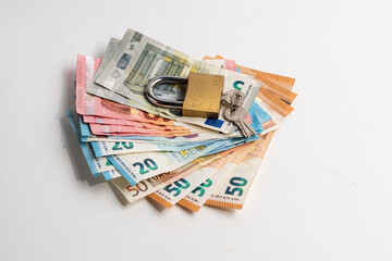 Padlock on a group of euro currency banknotes. Money lock, 