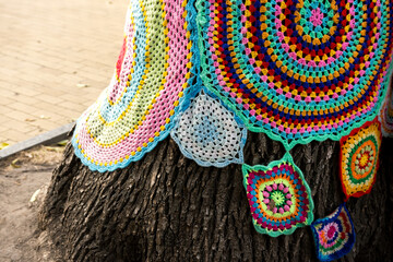 yarnbombing tree with trinkets close-up