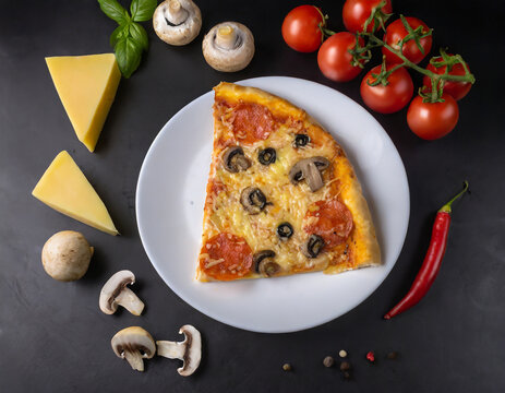 On a plate a piece of beautiful pizza, next to a black background ingredients - tomato, pepper, mushrooms,cheese