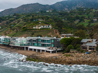 Malibu beach aerial view in California near Los Angeles, USA. Waves hitting the shore near...