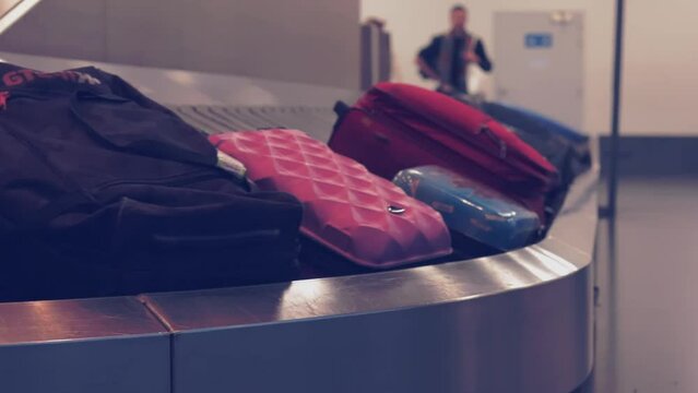 Traveling by airplane. tourists' bags on baggage claim in airport terminal. Wheeled suitcases on a luggage belt at the airport terminal. Baggage carousel. 
